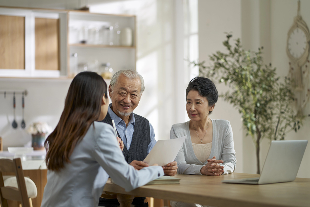 An old couple listen to a women
