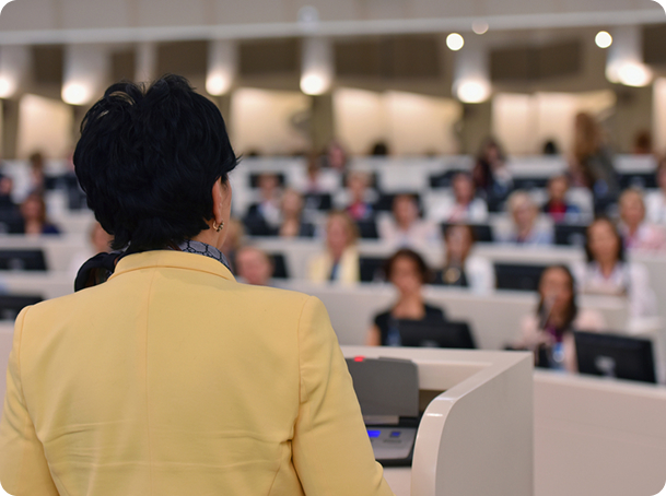 A women is giving speech to audience
