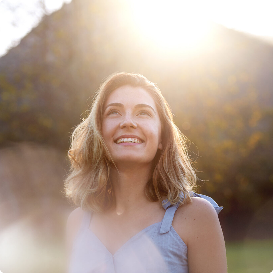 A woman is looking up to the sky